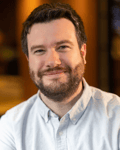 Peter Knox, book marketer and publishing consultant, smiling in a light blue button-down shirt